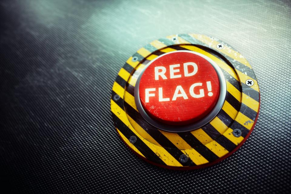 A large red button with the words red flag on it.