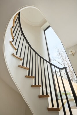 Sculptural staircase in front a double-