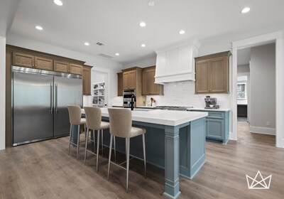 Royal Texan Homes design kitchen with custom two toned cabinets and commercial grade refrigerator